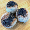 Close-up of organic geode bath bomb showing natural rose and mineral texture — non-GMO and cruelty-free
