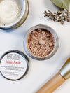 Close-up of Butter Me Up Organics natural setting powder showing certified organic ingredients label