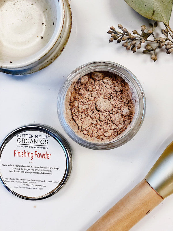 Close-up of Butter Me Up Organics natural setting powder showing certified organic ingredients label