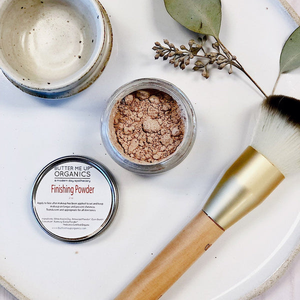 Butter Me Up Organics organic translucent finishing powder in a heavyweight glass jar with metal lid