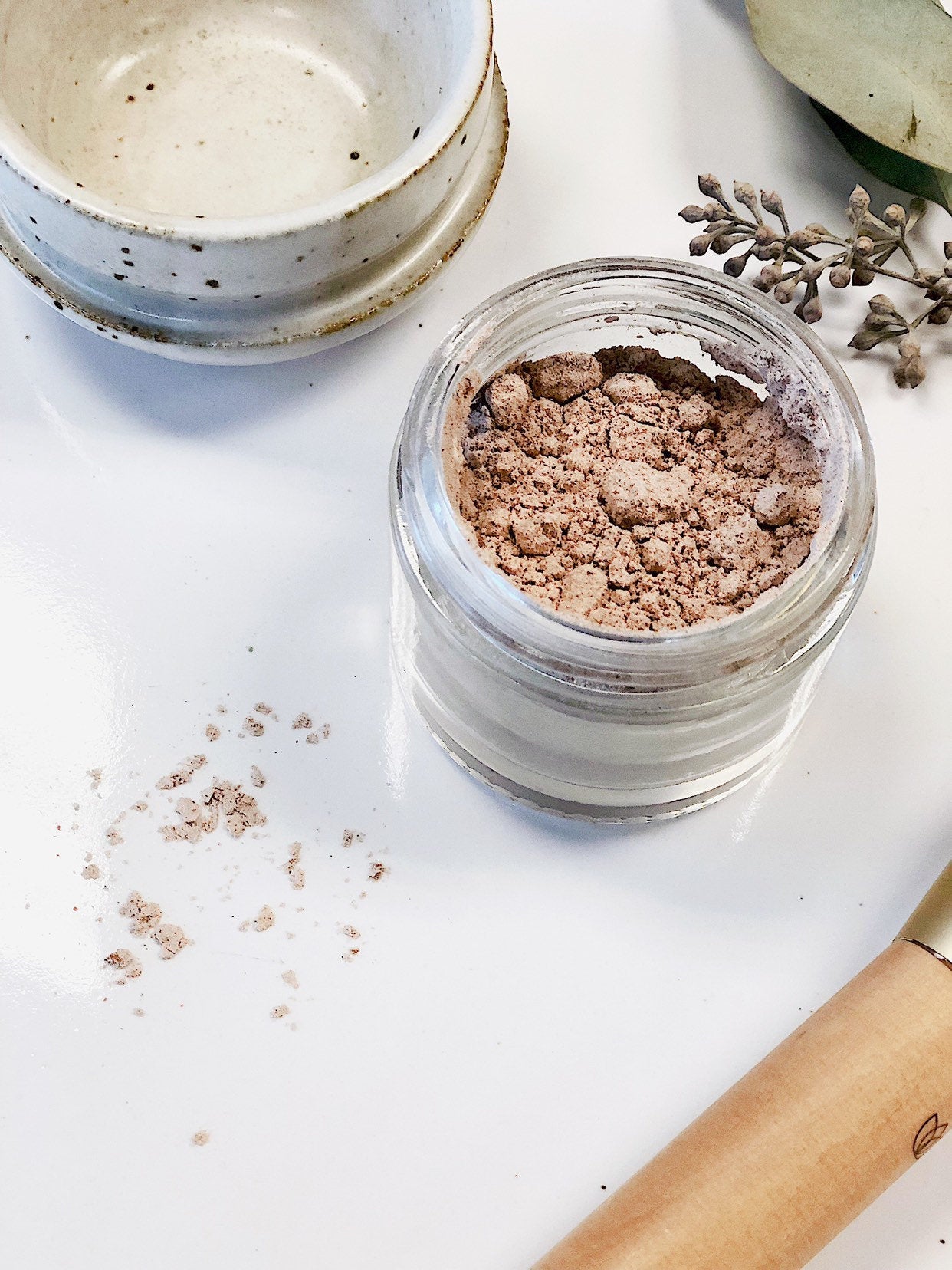 Butter Me Up Organics organic finishing powder displayed on a flat lay surface — plastic-free, cruelty-free makeup