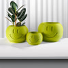 Close-up of smiley face drainage pattern on the base of a sustainable PLA plant pot