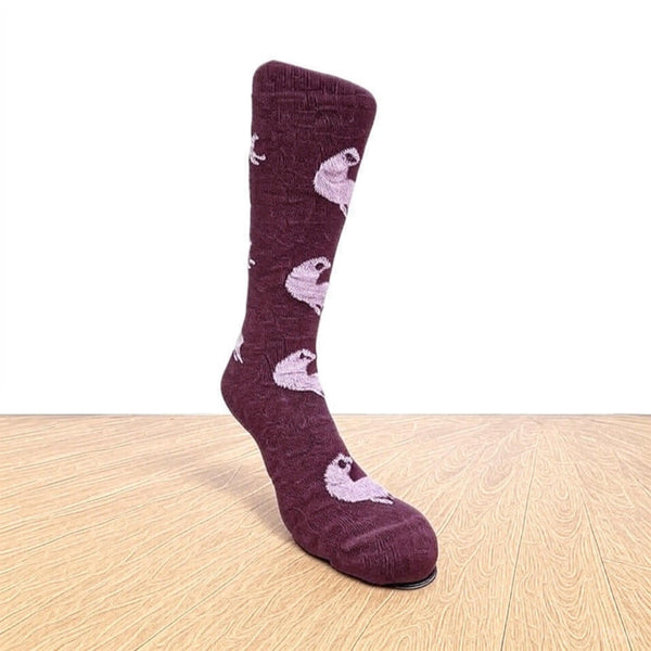 Maroon sock with dog pattern on a wooden floor. Discover our fun Pronk & Play Alpaca Socks, featuring a cheerful design for adults and kids. Made with a soft alpaca blend, these USA-designed socks are comfortable and durable. Shop now and add a little joy to your step.