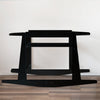 Plum+Sparrow black painted pine wood rocking Moses bassinet stand with brake on a light nursery floor