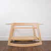 Plum+Sparrow natural pine Moses bassinet stand with Moses basket attached, styled in a nursery setting