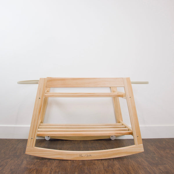 Plum+Sparrow natural pine Moses bassinet stand with Moses basket attached, styled in a nursery setting