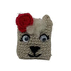 Close-up of a hand-crocheted llama ornament showing unique facial details in 100% organic wool