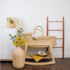 Close-up of the rocking brake mechanism on the Plum+Sparrow natural pine Moses basket stand