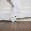 Plum+Sparrow rocking Moses bassinet stand styled in a nursery with white Moses basket