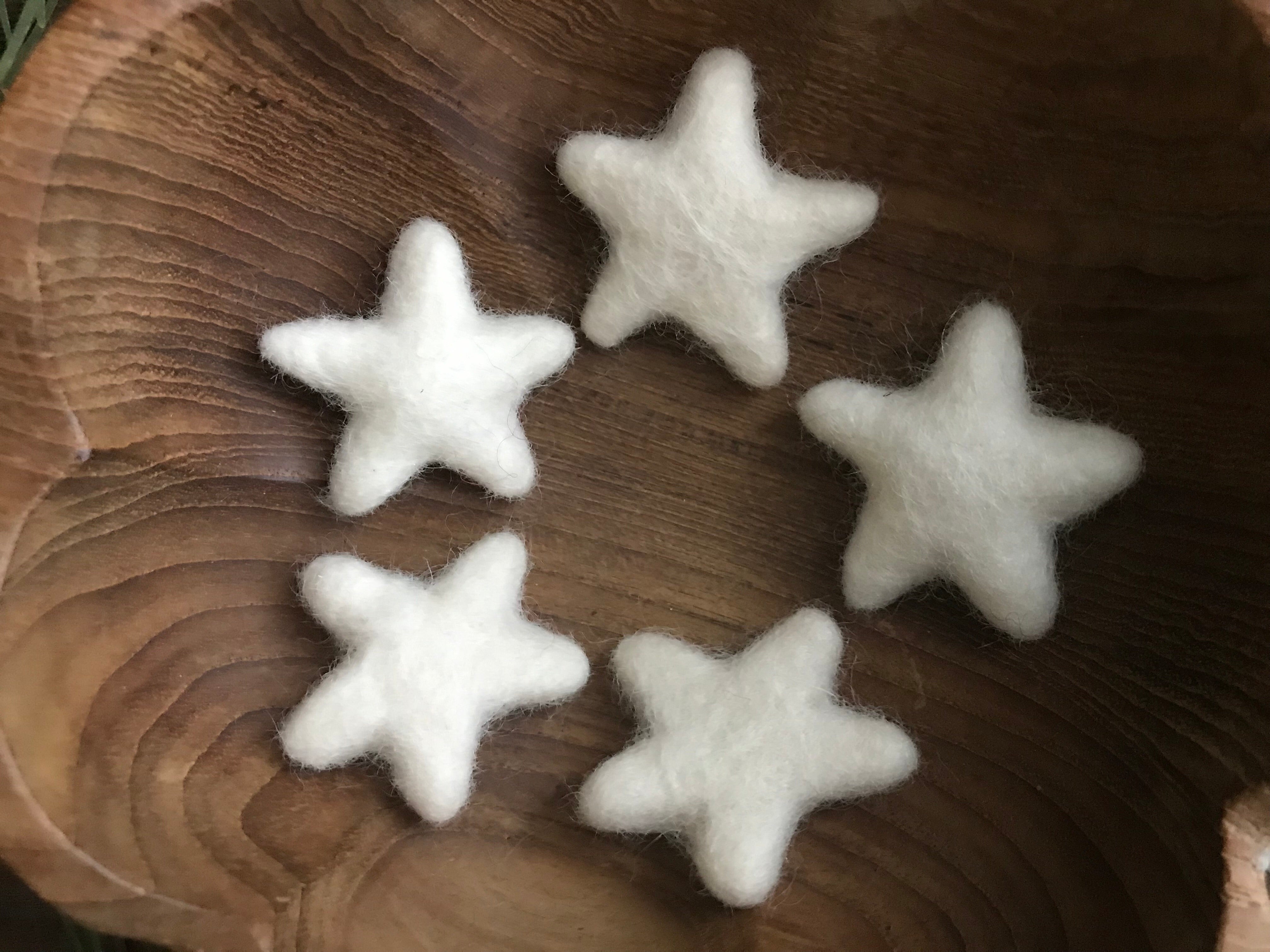 Close view of handmade Snowberry White felted wool stars from House of Moss