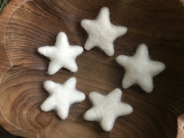 Close view of handmade Snowberry White felted wool stars from House of Moss