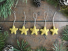 Set of five gold clay yellow needle-felted wool star ornaments with cotton string loops