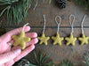 Close view of a gold clay yellow needle-felted wool star ornament