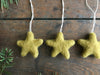 Wool star ornaments in gold clay yellow from the House of Moss set of 5