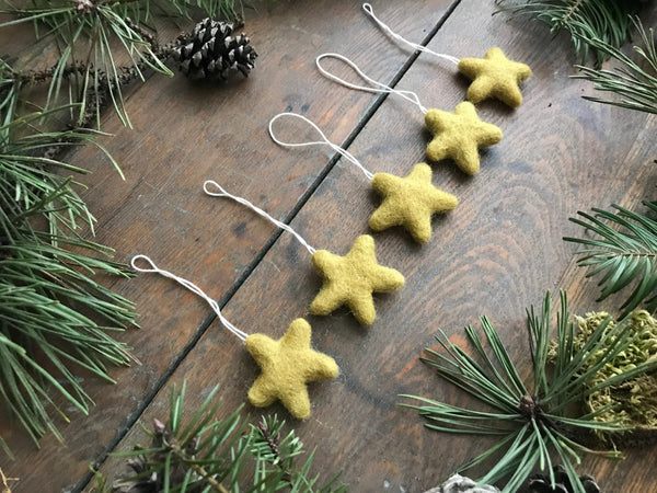 Gold clay yellow wool star ornaments with hanging loops of cotton string