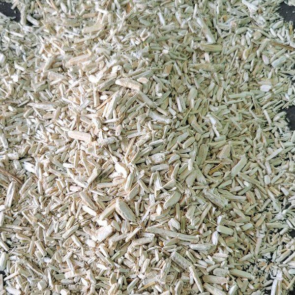 Close-up of dried herbs on a black surface