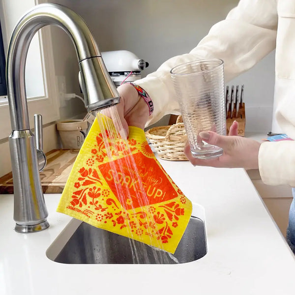 Soak iT Up Swedish dishcloth with cheerful It's a Beautiful Day print on a kitchen counter