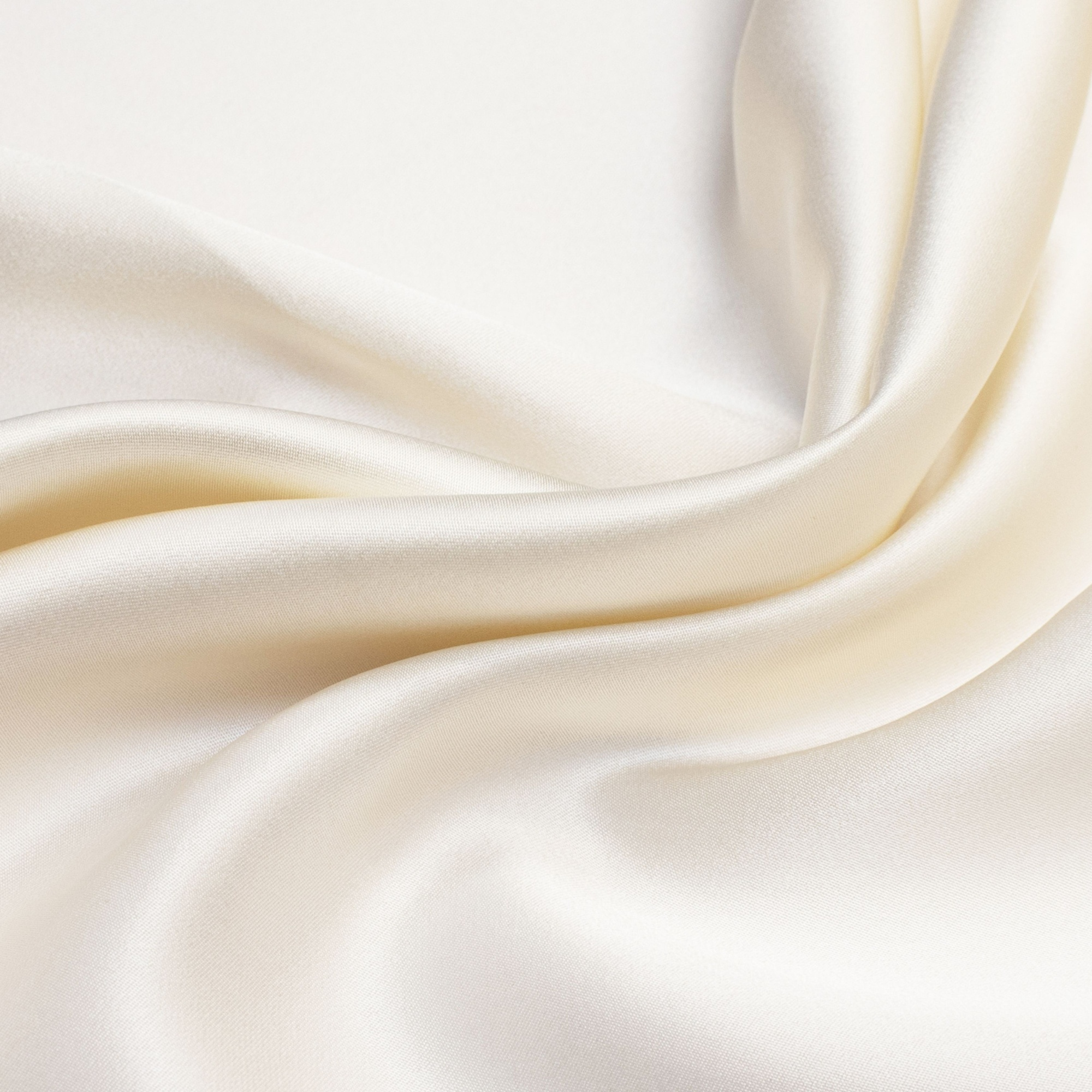 Close-up of smooth, white fabric with soft folds