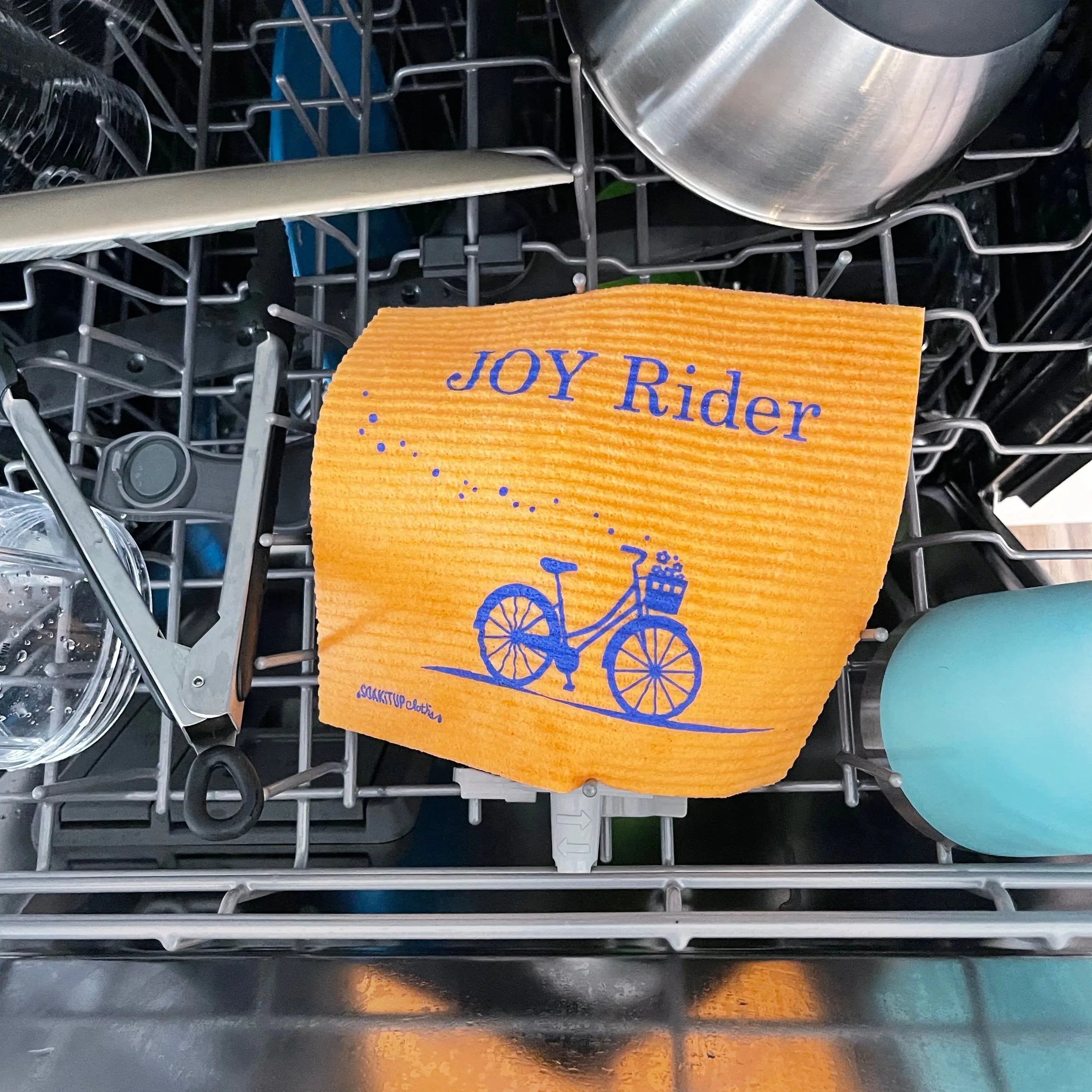 Joy Rider Swedish dishcloth in use on a kitchen counter – sustainable cleaning gift for cyclists