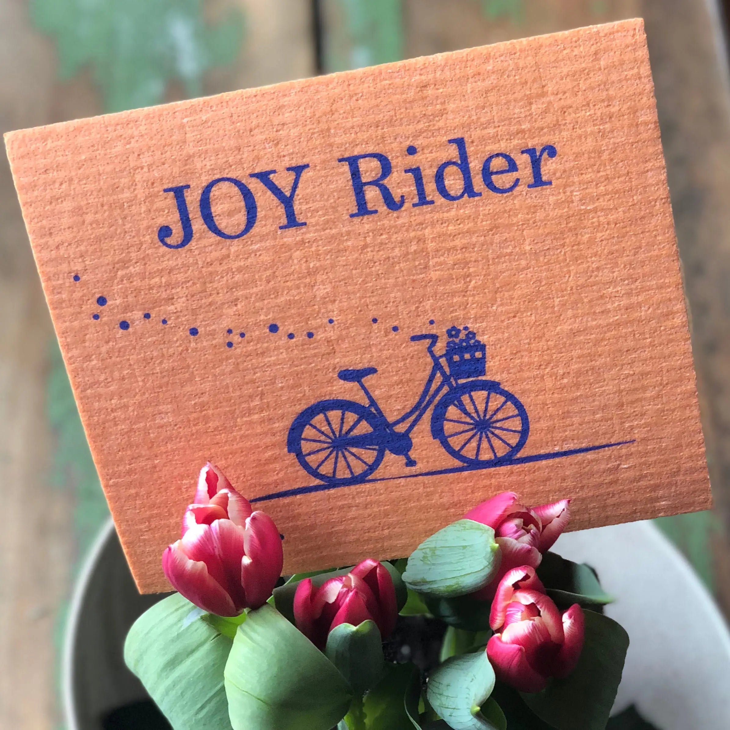 Joy Rider bike-themed Swedish dishcloth laid flat showing full cycling print design