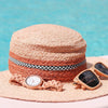 Straw hat with sunglasses and watch on a blue background