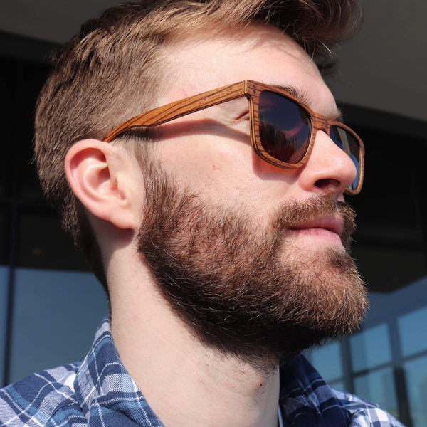 Joycoast wooden sunglasses and wood watches lifestyle flat lay showcasing natural zebrawood accessories