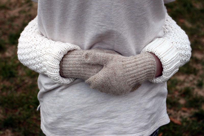 Toddler-size alpaca mittens in natural Suri shades on a neutral background