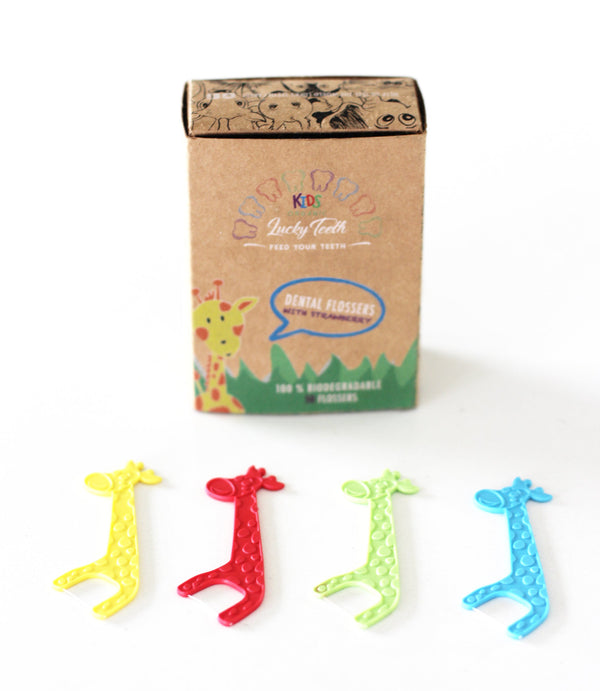 Colorful giraffe-shaped dental picks with a cardboard box on a white background