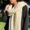 Person wearing a large beige scarf outdoors