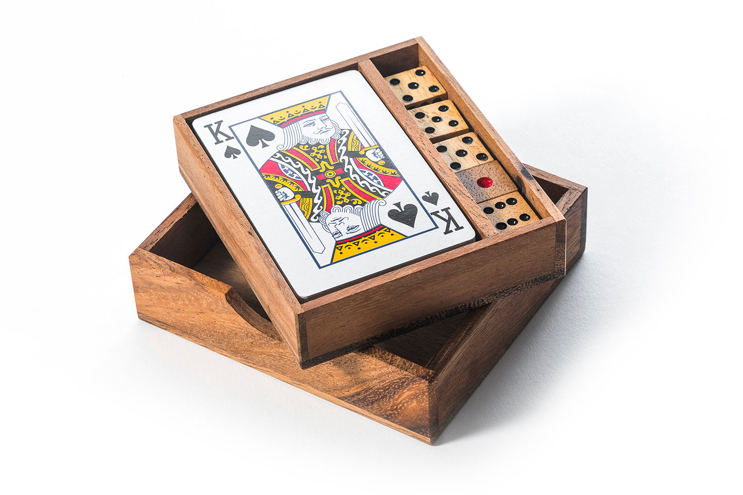 Wooden box containing playing cards and dominoes on a white background