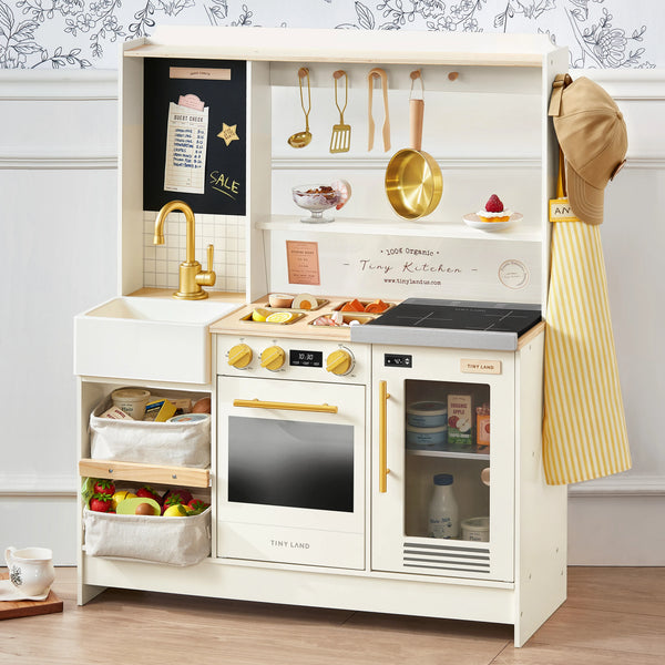 Children's play kitchen set with various accessories on a neutral background