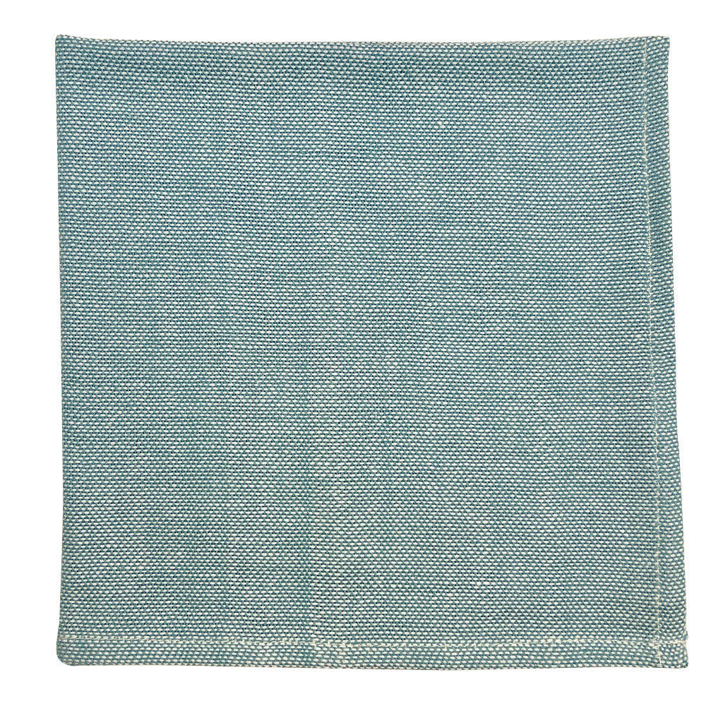Textured teal square pillow on a white background