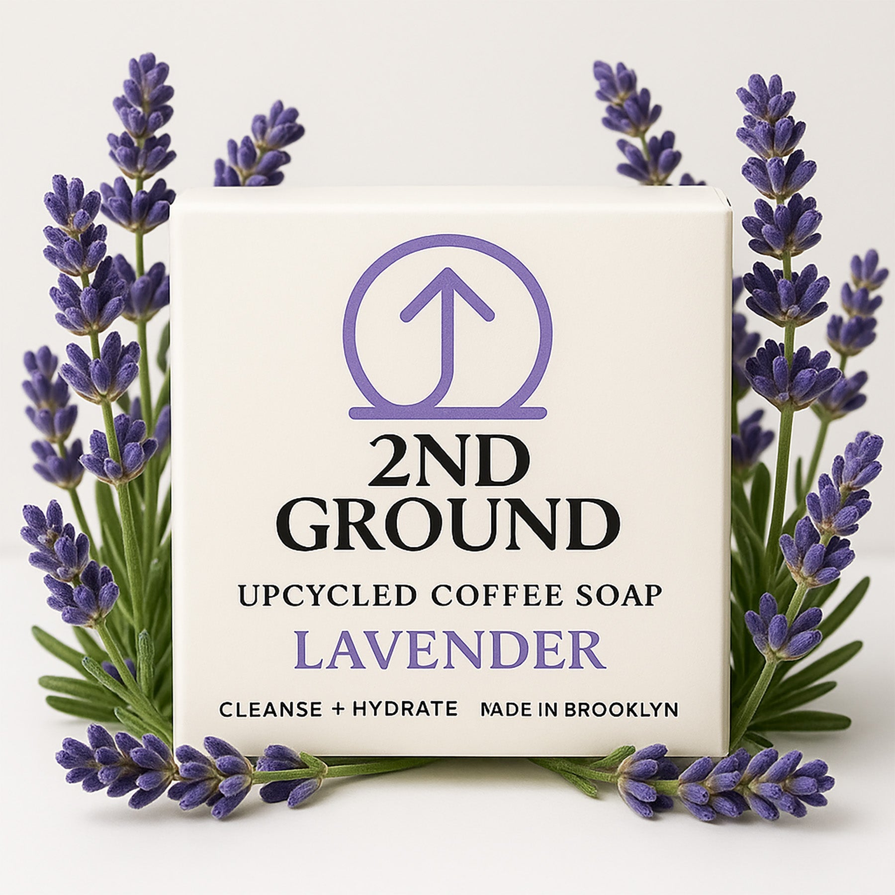 2nd Ground upcycled coffee soap bar with lavender scent surrounded by lavender flowers on a light background