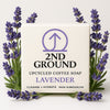 2nd Ground upcycled coffee soap bar with lavender scent surrounded by lavender flowers on a light background