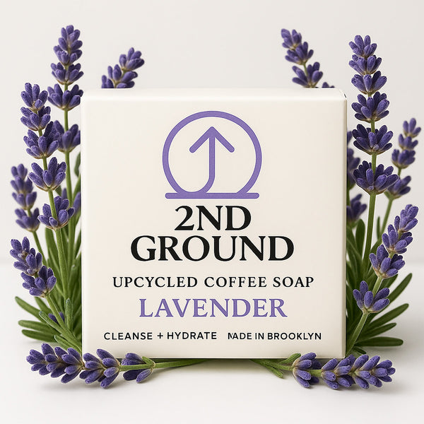 2nd Ground upcycled coffee soap bar with lavender scent surrounded by lavender flowers on a light background