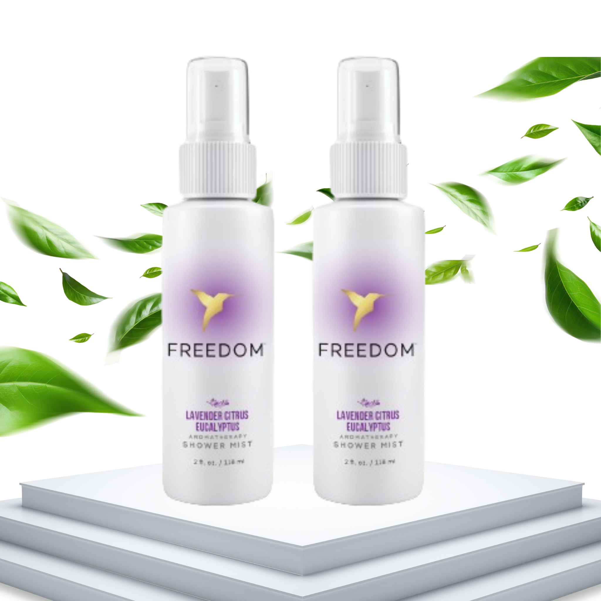 Two 'Freedom' shower mist bottles with green leaves in the background