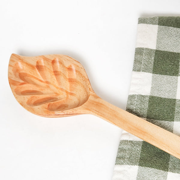 Hand-carved wood leaf spoon: unique, reclaimed, fair trade. Stir with nature's touch & support artisans! ✨