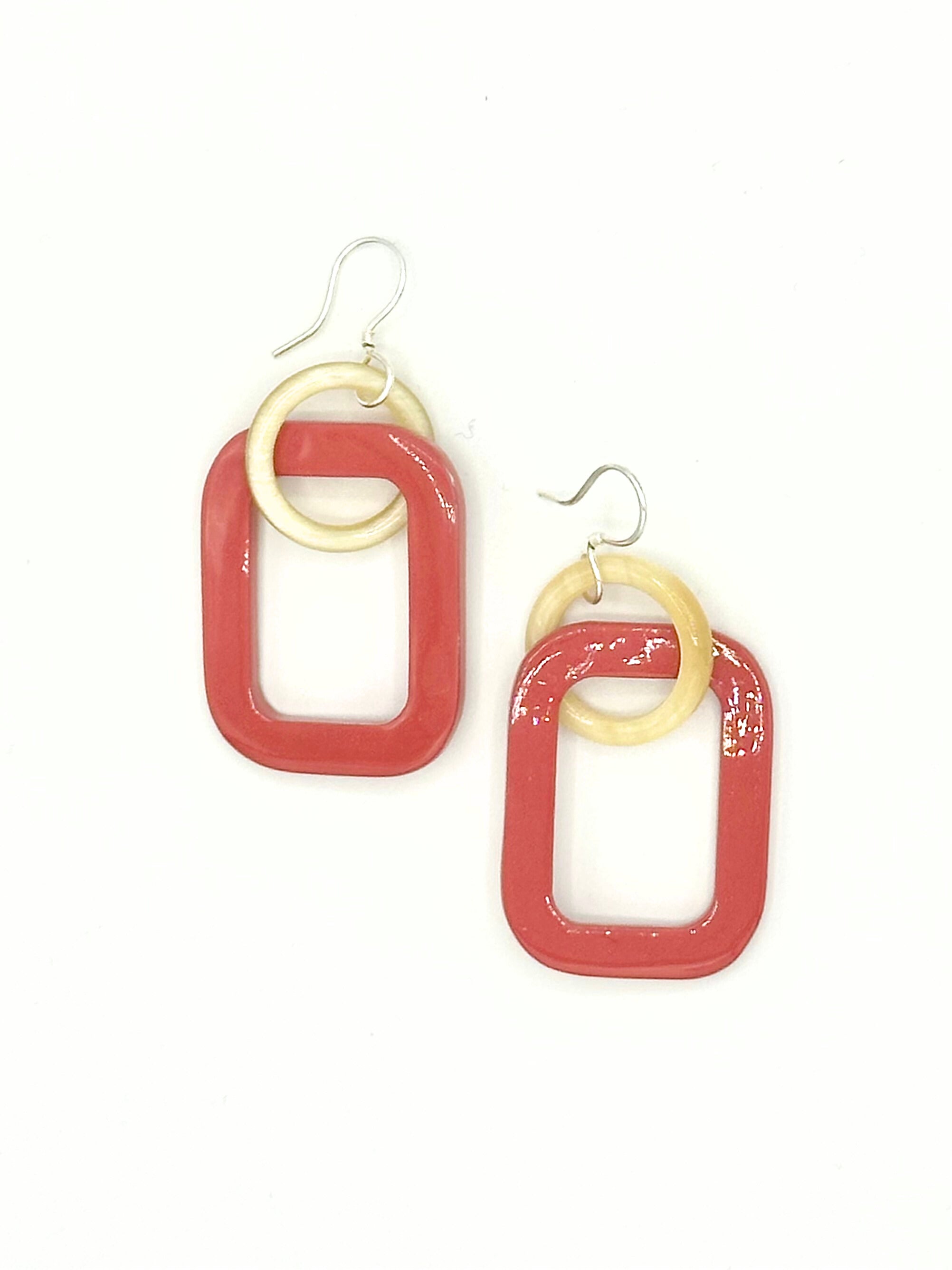 Close-up of Fair Anita linked horn earrings showing lacquered finish and connected pendant design