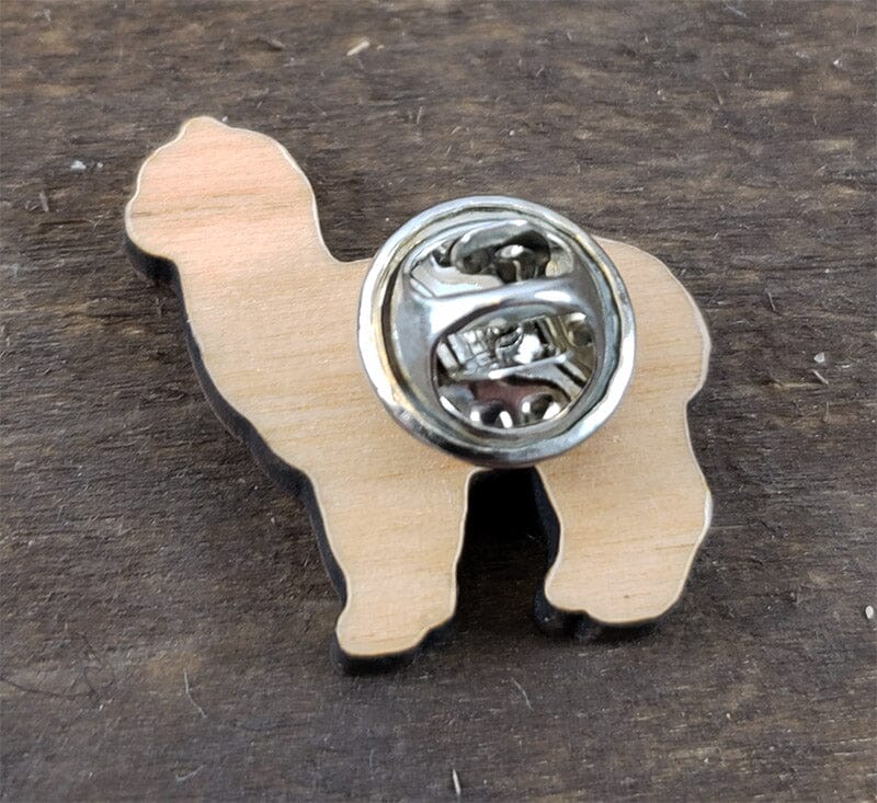 Wooden dog-shaped bottle opener on a wooden surface