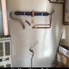 Plumbing setup with pipes and valves on a wall