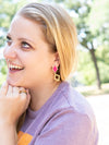 Magenta and brass rhombus earrings laid flat showing bold colour and geometric design by Fair Anita