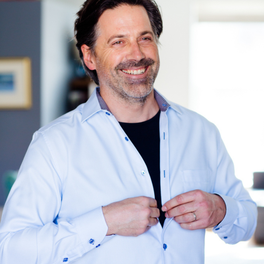 Man layering Remedywear™ long sleeve eczema shirt under a business shirt for all-day relief