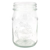 Clear glass mason jar with embossed design on a white background