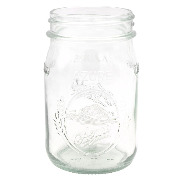 Clear glass mason jar with embossed design on a white background