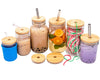 Set of mason jars with wooden lids and straws on a white background