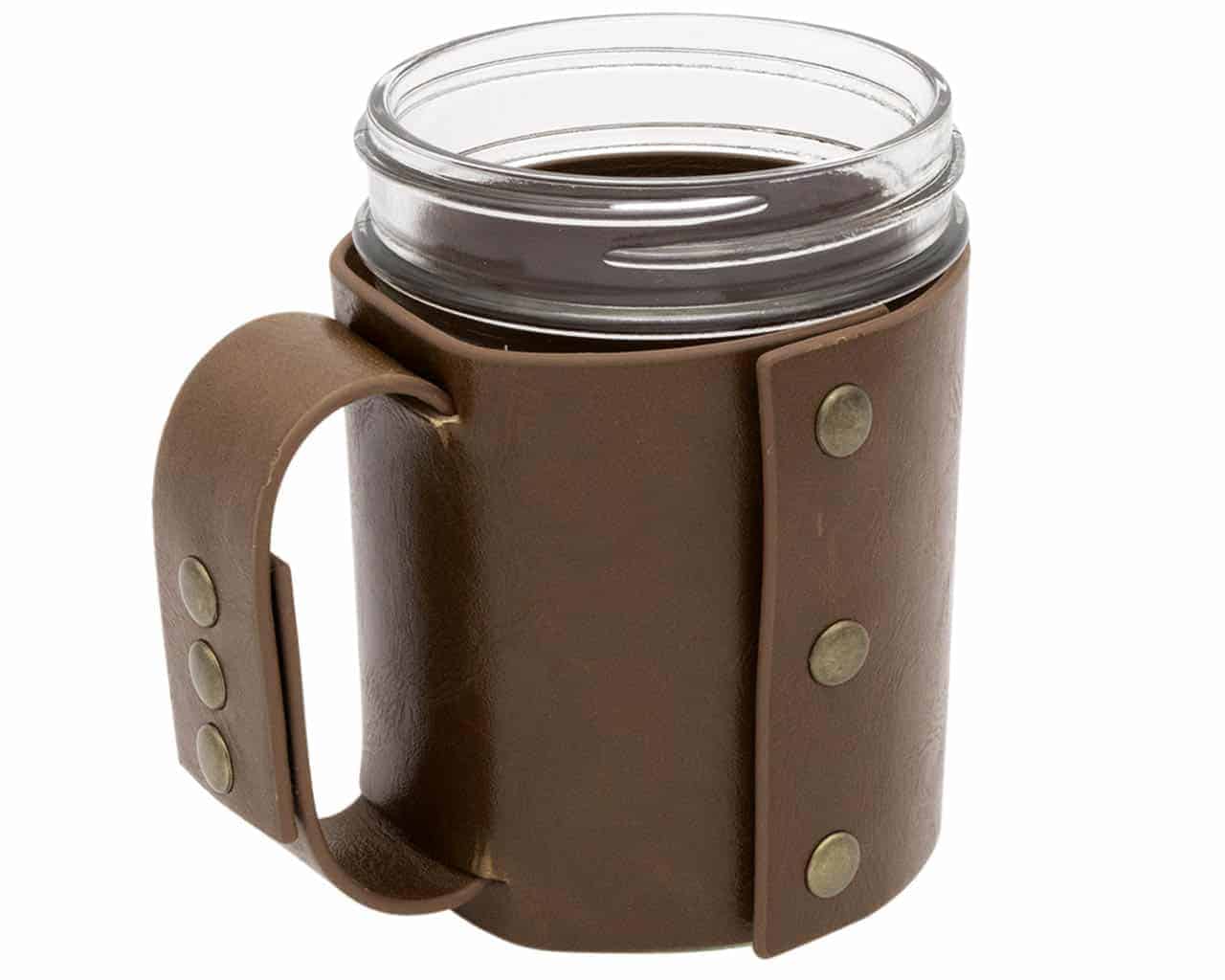 Clear mug with brown leather sleeve on a white background
