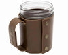 Clear mug with brown leather sleeve on a white background