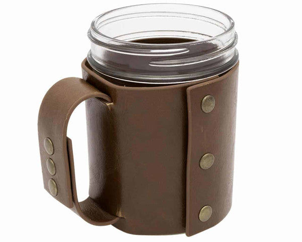 Clear mug with brown leather sleeve on a white background