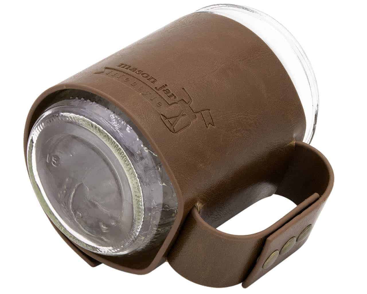 Brown leather mug with a clear plastic lid on a white background
