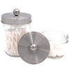 Glass jar with silver lid containing cotton swabs on a white background